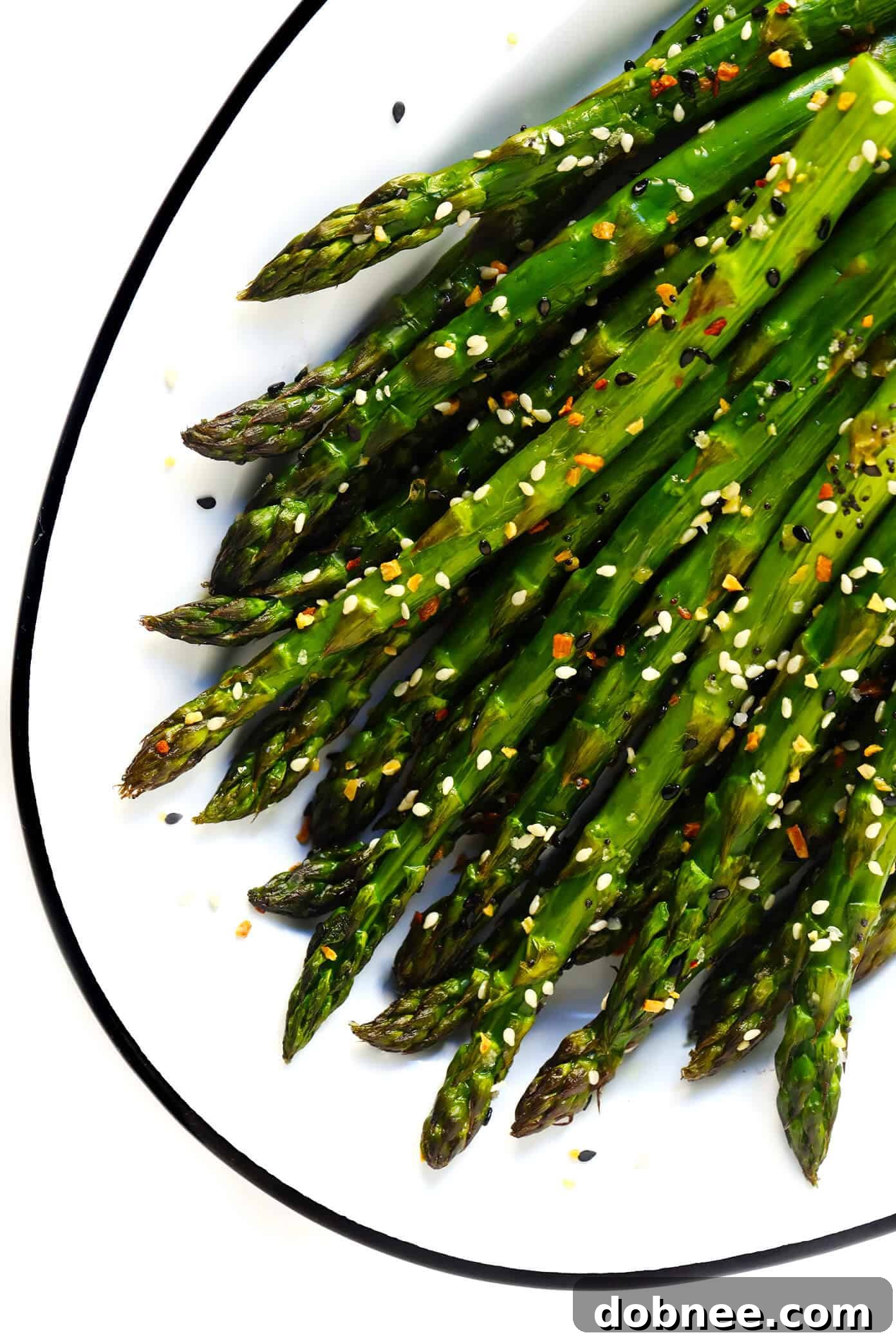 Kick your roasted asparagus recipe up a notch this season with some everything bagel seasoning! It's super quick and easy to make, naturally vegan and gluten-free, and makes the most delicious healthy side dish. Warm "Everything" Roasted Asparagus, garnished with sea salt.