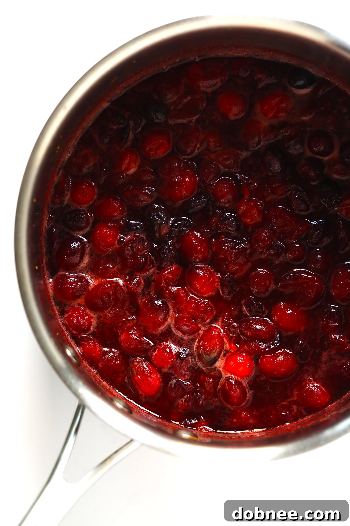Bowl of fresh cranberries and orange zest, key ingredients for the sauce