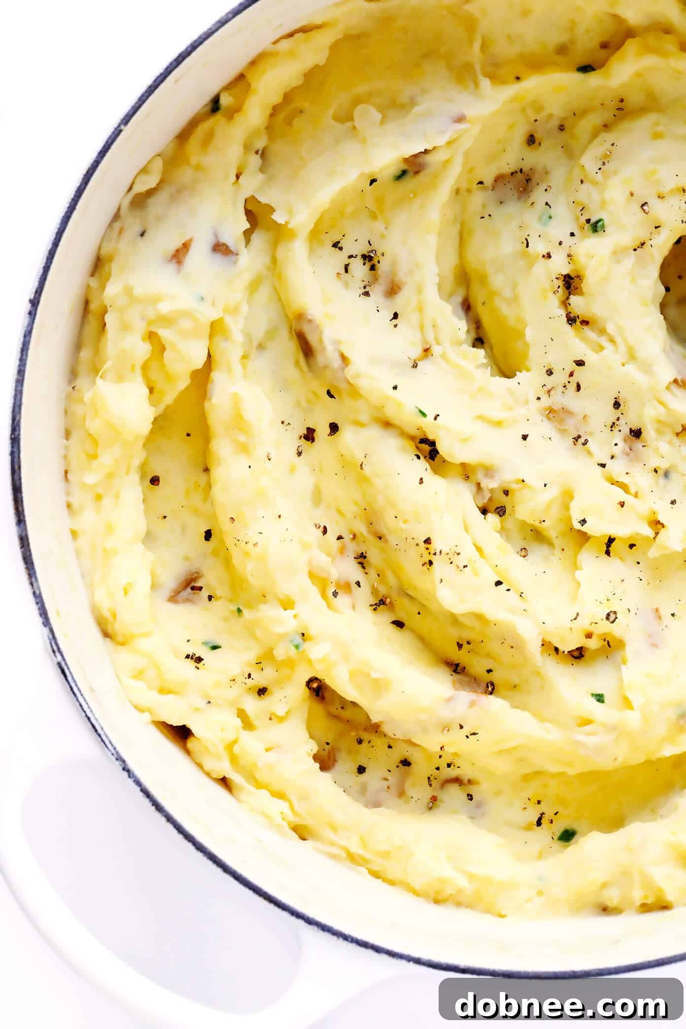 The BEST Mashed Potatoes recipe: perfectly rich, creamy, and buttery homemade mashed potatoes with great flavor, easy to make, and a crowd favorite for Thanksgiving, Christmas, or any dinner, optionally served with Mushroom Gravy.