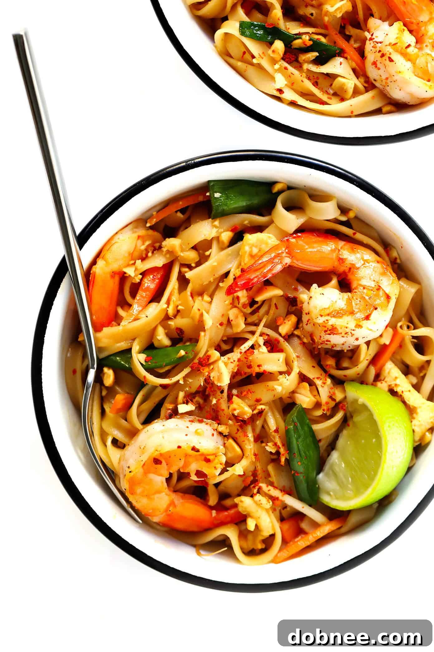 Shrimp Pad Thai garnished with fresh cilantro, lime, and peanuts