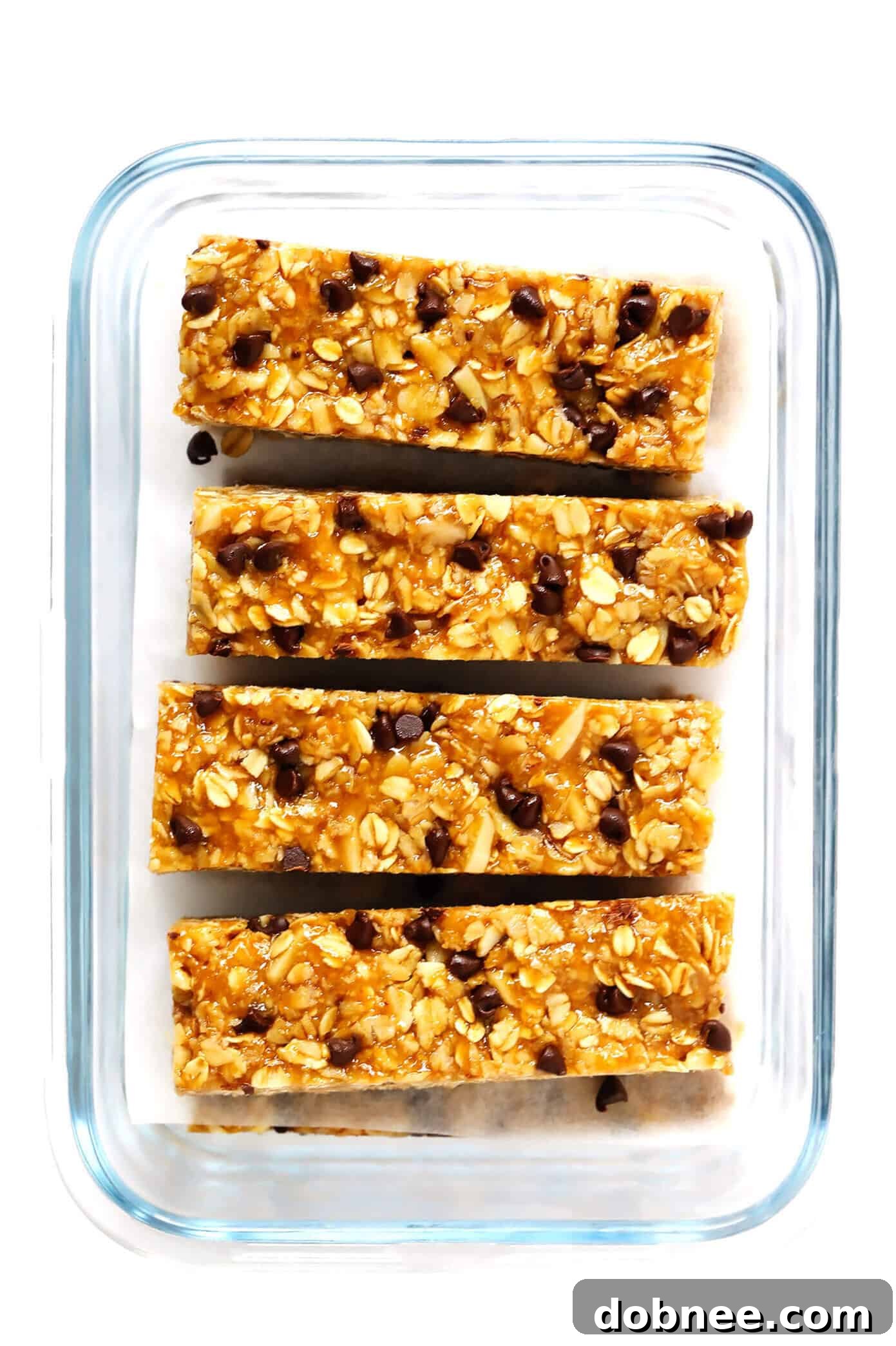 Delicious Chewy Peanut Butter Granola Bars stacked with a bite taken out, showcasing the chewy texture and chocolate chips.