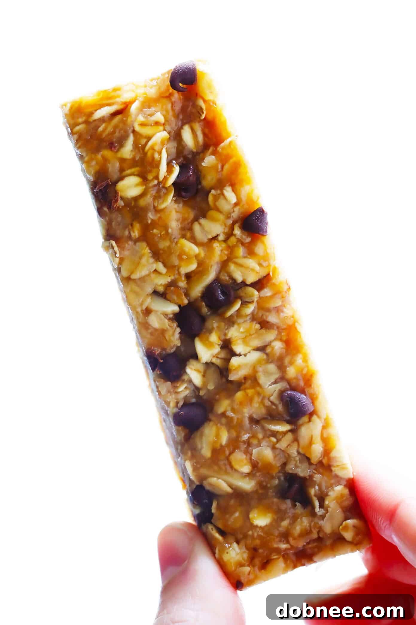 A stack of golden brown chewy peanut butter granola bars with visible oats, nuts, and melted chocolate chips, ready to be enjoyed as a healthy snack.