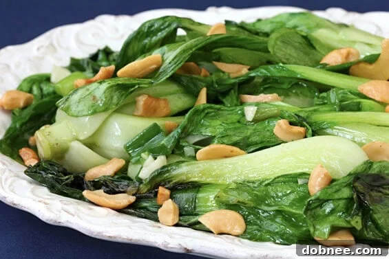 Freshly cooked baby bok choy with cashews, a vibrant and healthy side dish.