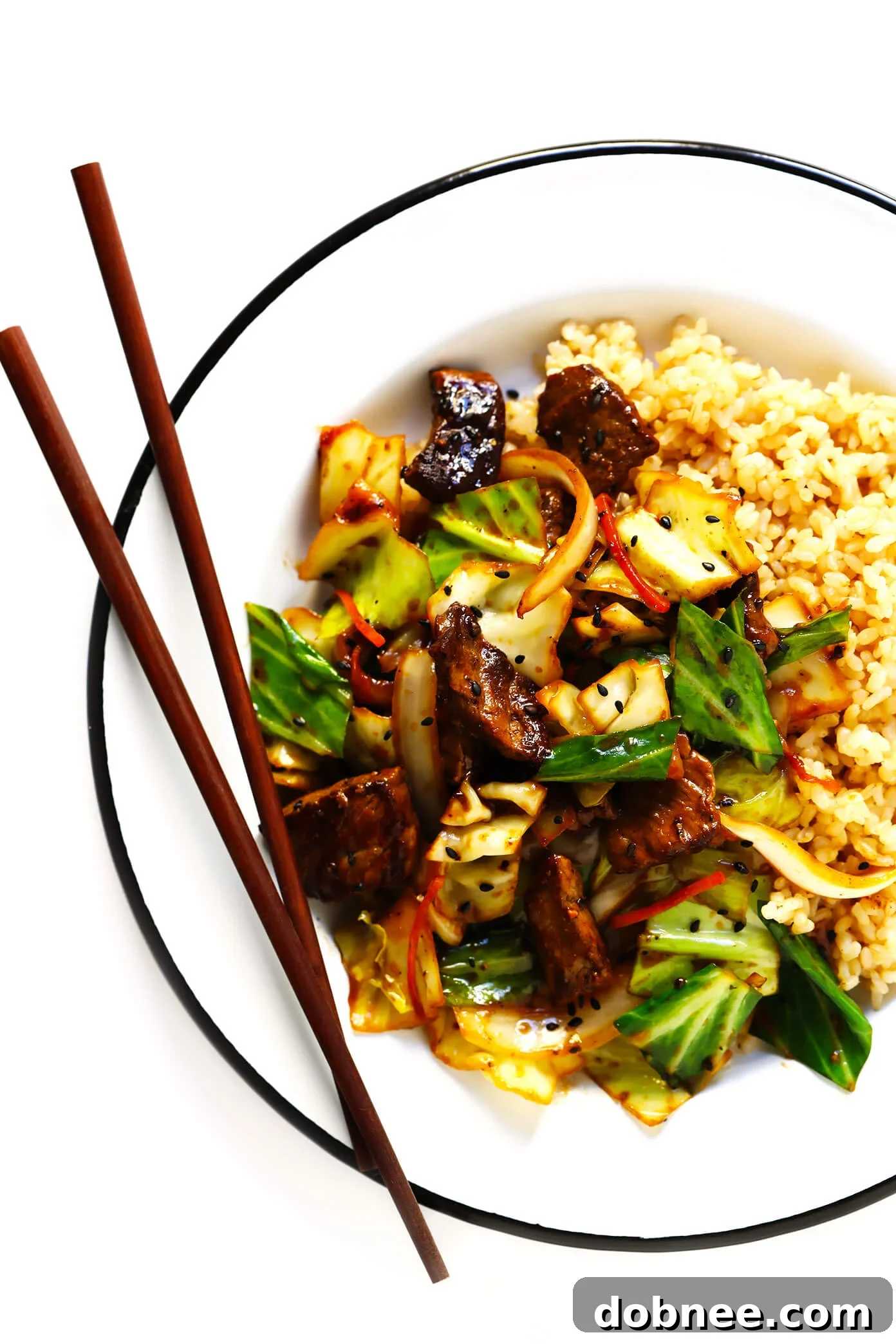 Delicious Sesame Beef and Cabbage Stir-Fry served over rice for a complete meal