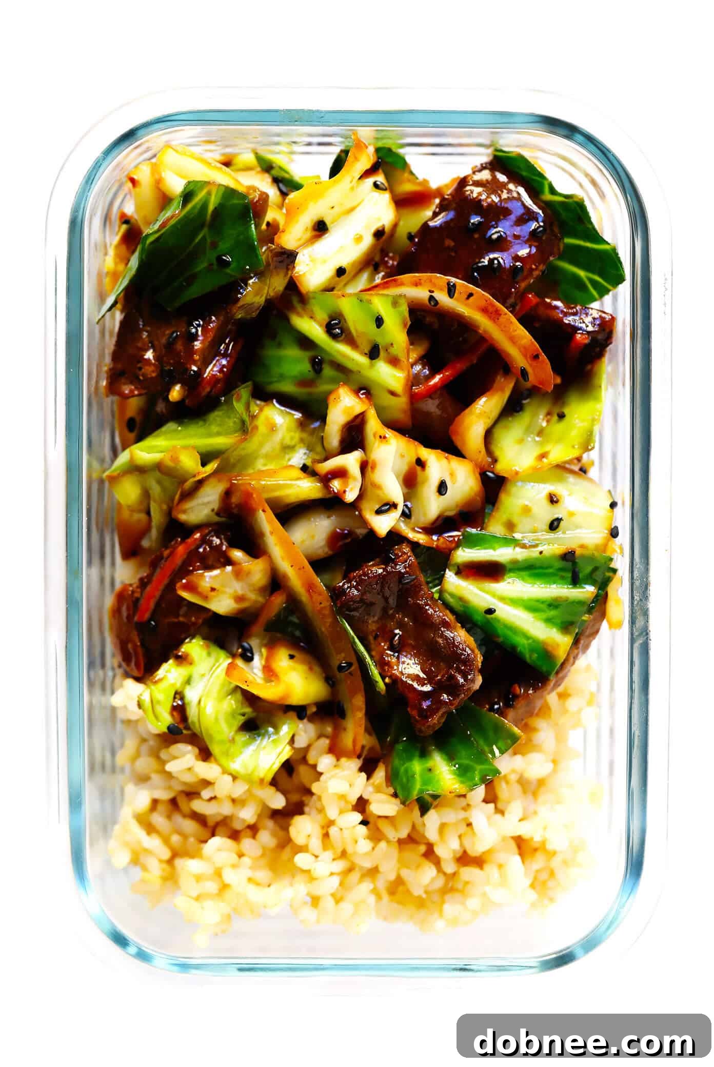 Meal prep containers with Sesame Beef and Cabbage Stir-Fry and brown rice