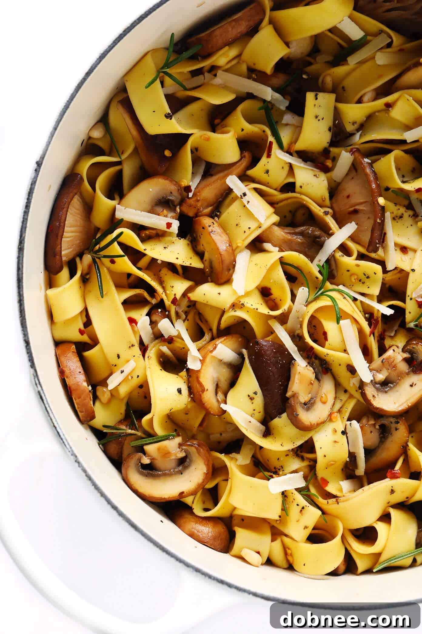 Delicious Mushroom Pasta with Parmesan Mushroom Lovers Pasta served in a bowl, topped with Parmesan cheese