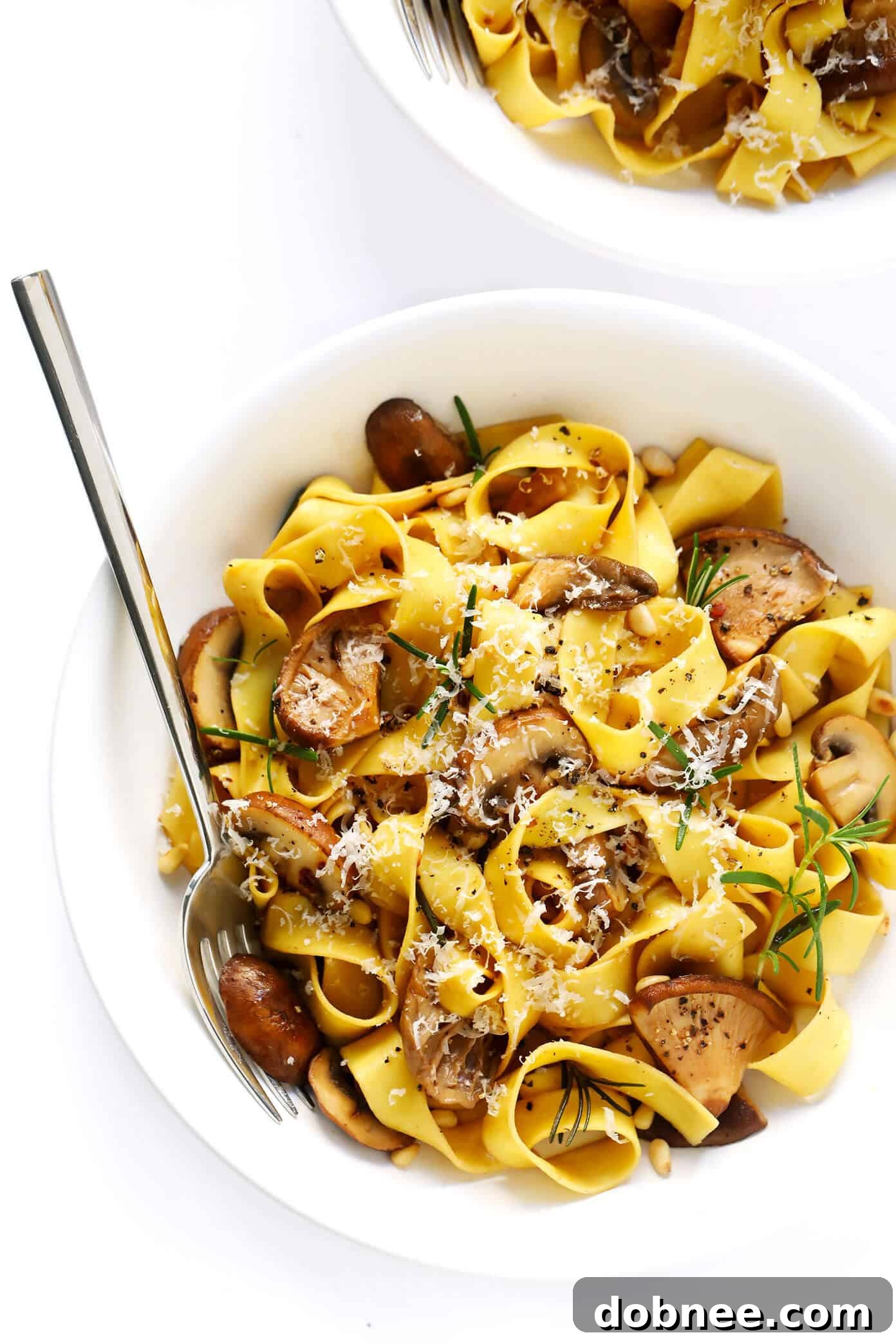 Exquisite Mushroom Lovers Pasta with Rosemary and Parmesan Close-up of Mushroom Lovers Pasta garnished with fresh rosemary and Parmesan cheese