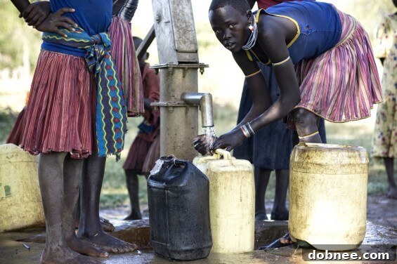 Women gathered around a newly constructed well, symbolizing access to clean water in Kenya.