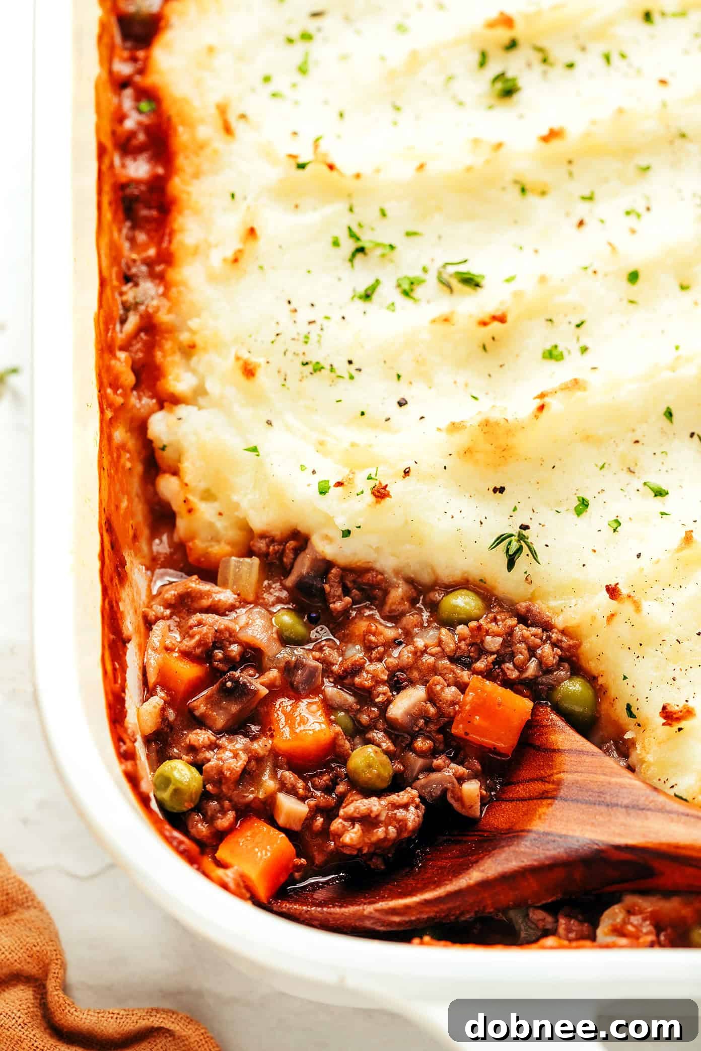 Individual servings of Shepherd's Pie with a side of fresh herbs