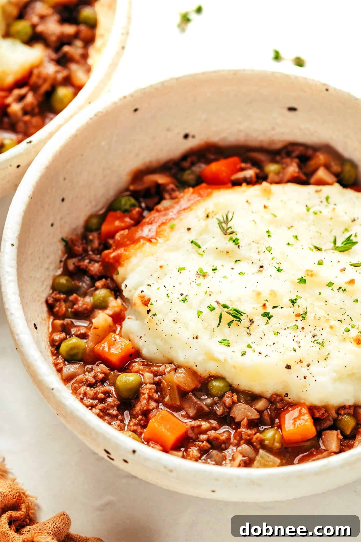 A slice of Shepherd's Pie on a white plate, ready to be served
