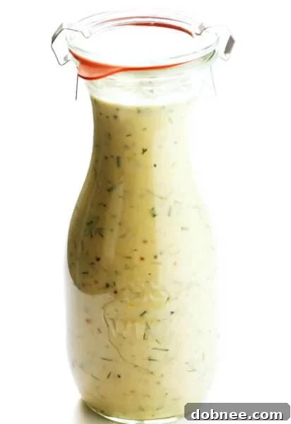 Creamy Tahini Ranch Dressing served over a fresh avocado chicken salad, with a side of dressing.