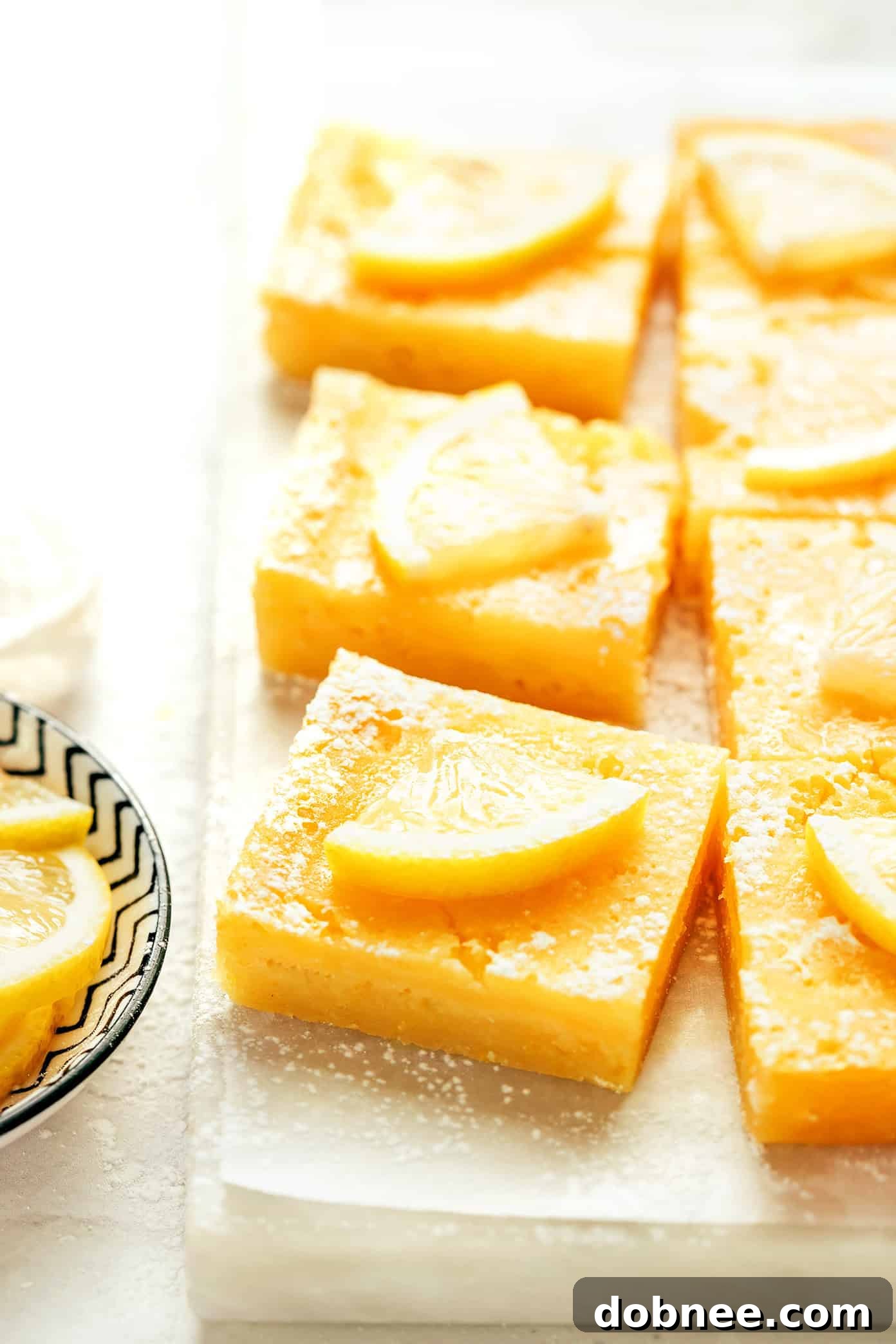 Delicious lemon bars resting on a cooling rack, freshly baked and dusted with powdered sugar.