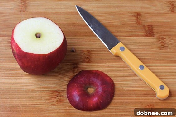 Close-up of a freshly hollowed apple ready to be filled, showing the smooth, clean interior of the apple cup.