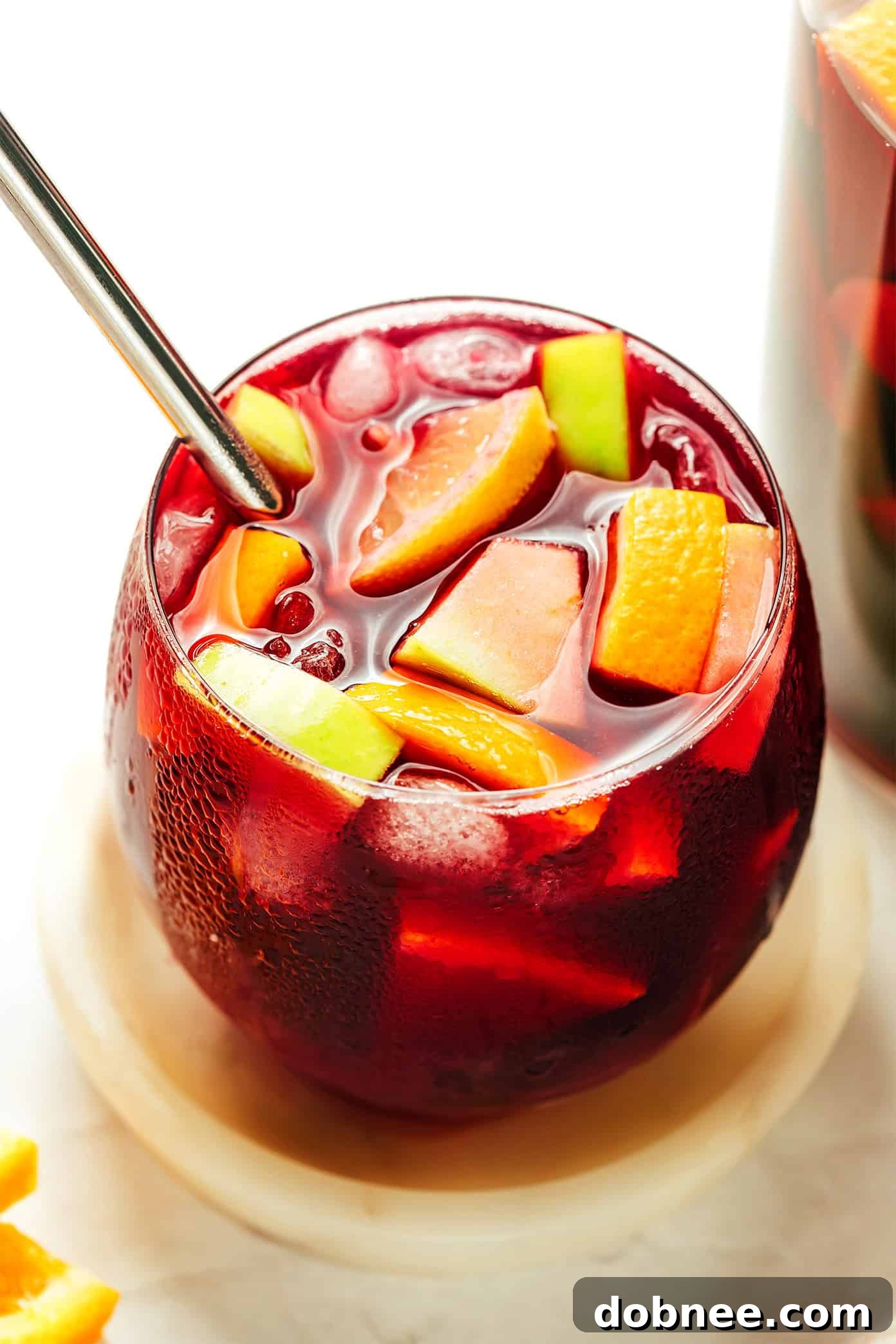 Several glasses of freshly poured Spanish Sangria, garnished with fruit and ready to be enjoyed, showcasing the vibrant color and refreshing appeal of the drink.