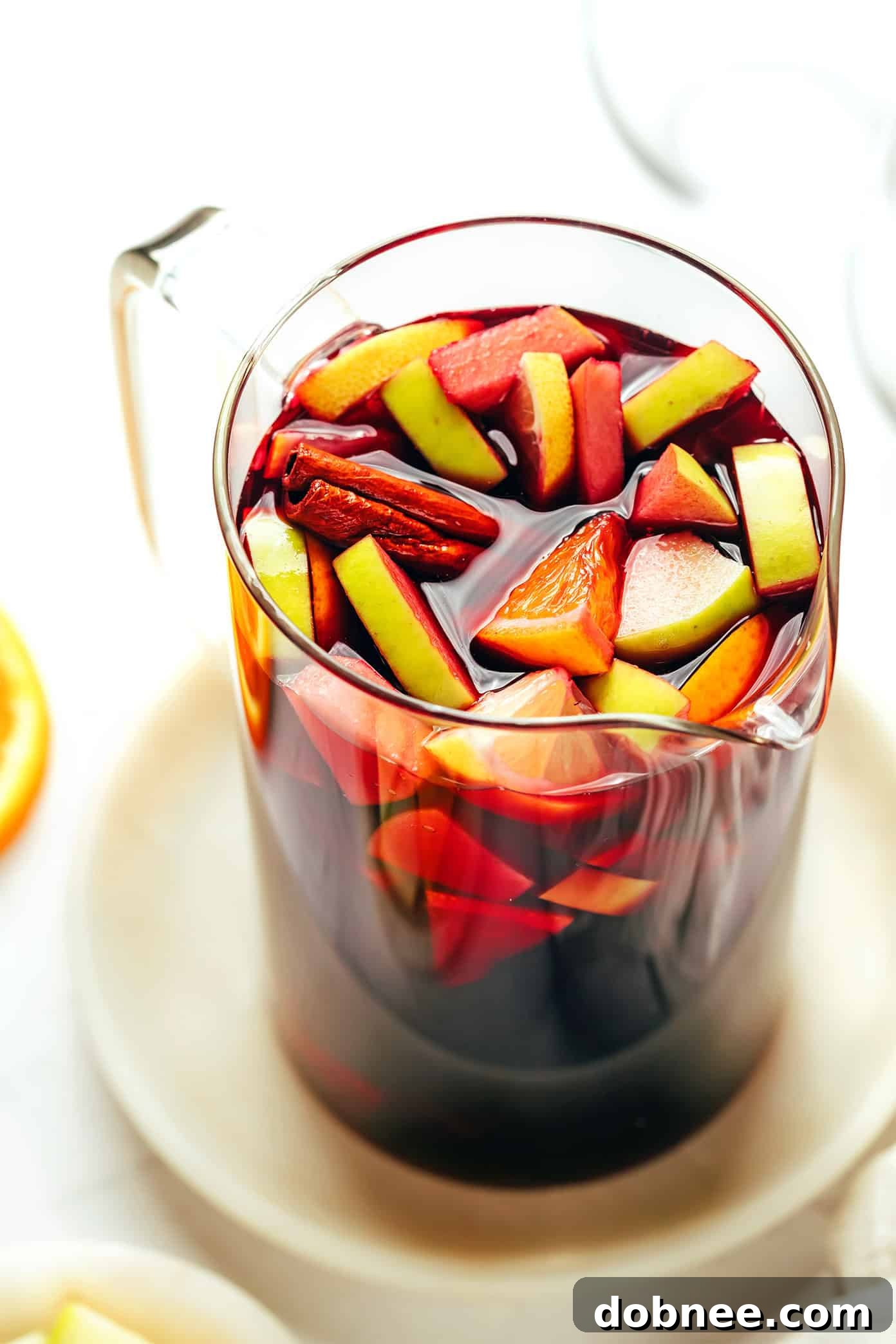 A vibrant selection of various glasses of sangria, each showcasing different fruit combinations and garnishes, set against a bright background, inviting enjoyment.