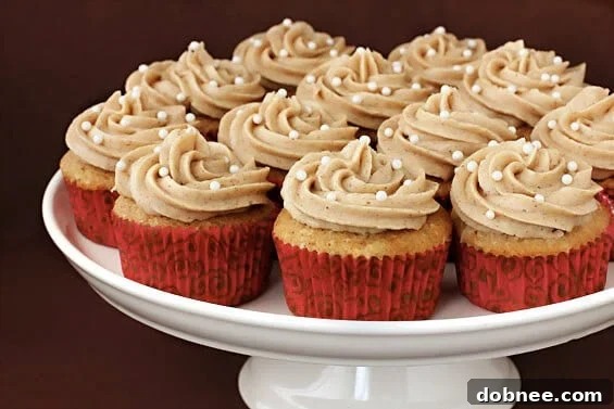 Delicious Vanilla Chai Cupcakes topped with creamy cinnamon buttercream and a sprinkle of chai spice, beautifully arranged for a tempting treat.