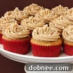 A perfectly baked vanilla chai cupcake with a swirl of cinnamon frosting, ready to be enjoyed.