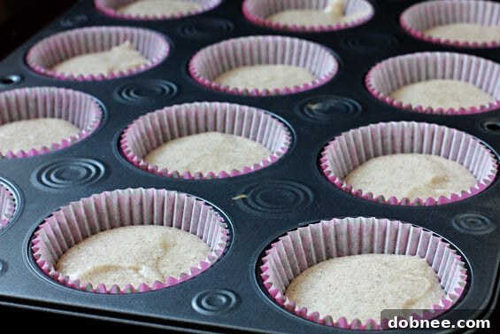 A top-down view of beautifully frosted Vanilla Chai Cupcakes, garnished with a sprinkle of warming chai spices, ready to be served.