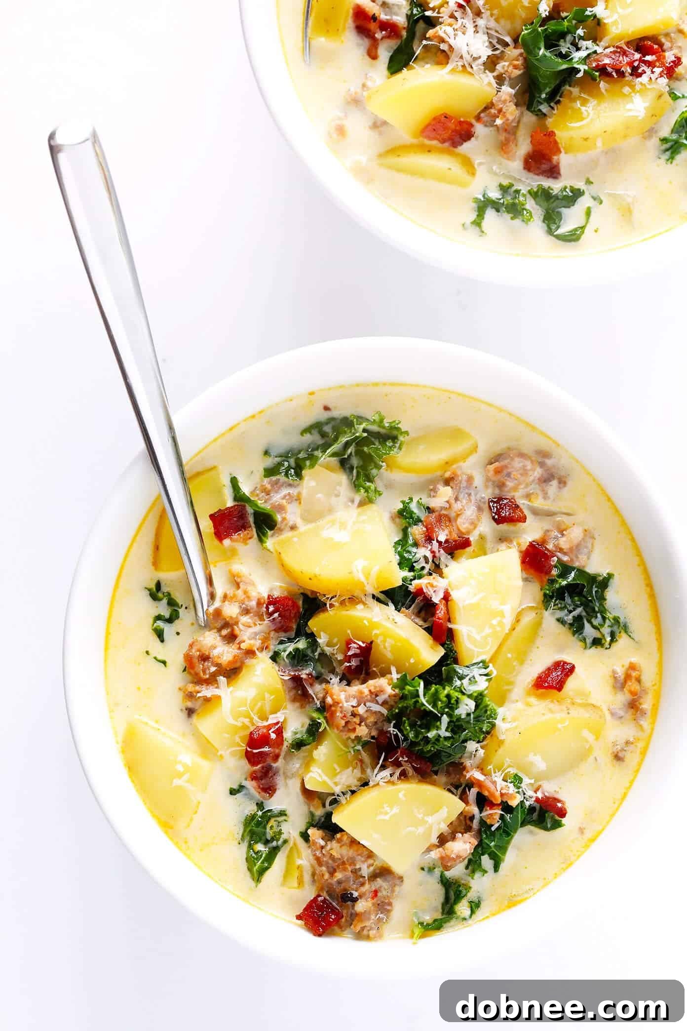 Learn how to make this favorite Olive Garden soup on the stovetop or in the slow cooker! This Zuppa Toscana recipe is super easy to make, naturally gluten-free, and full of the most delicious zesty, creamy flavors. So grab some Italian sausage, kale, potatoes, bacon, Parmesan, and garlic, and make it happen! Crock-pot instructions also included.
