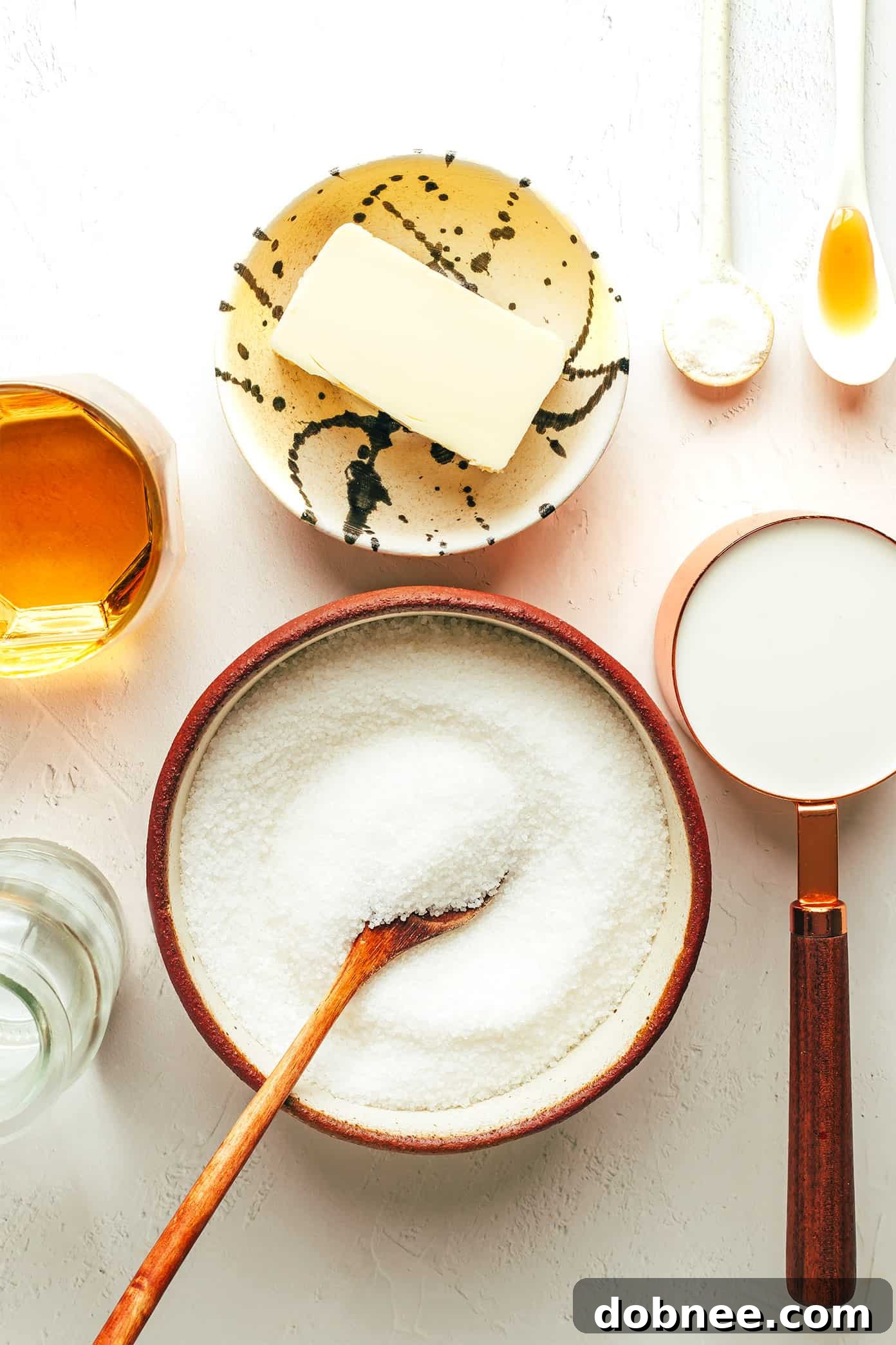 Close-up of a saucepan on a stove, showing the sugar and water mixture beginning to bubble and caramelize.