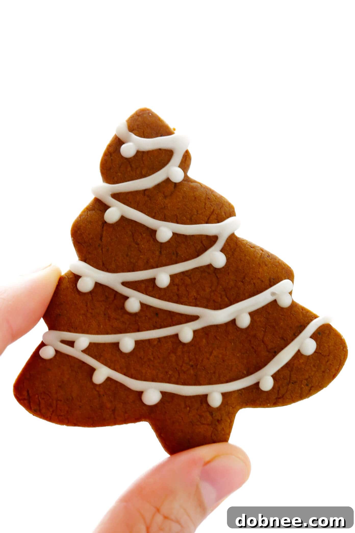Beautifully decorated gingerbread cookie Christmas tree with icing and sprinkles.