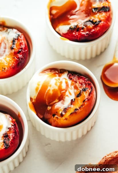 Grilled Peaches with Bourbon Caramel Sauce served with ice cream.