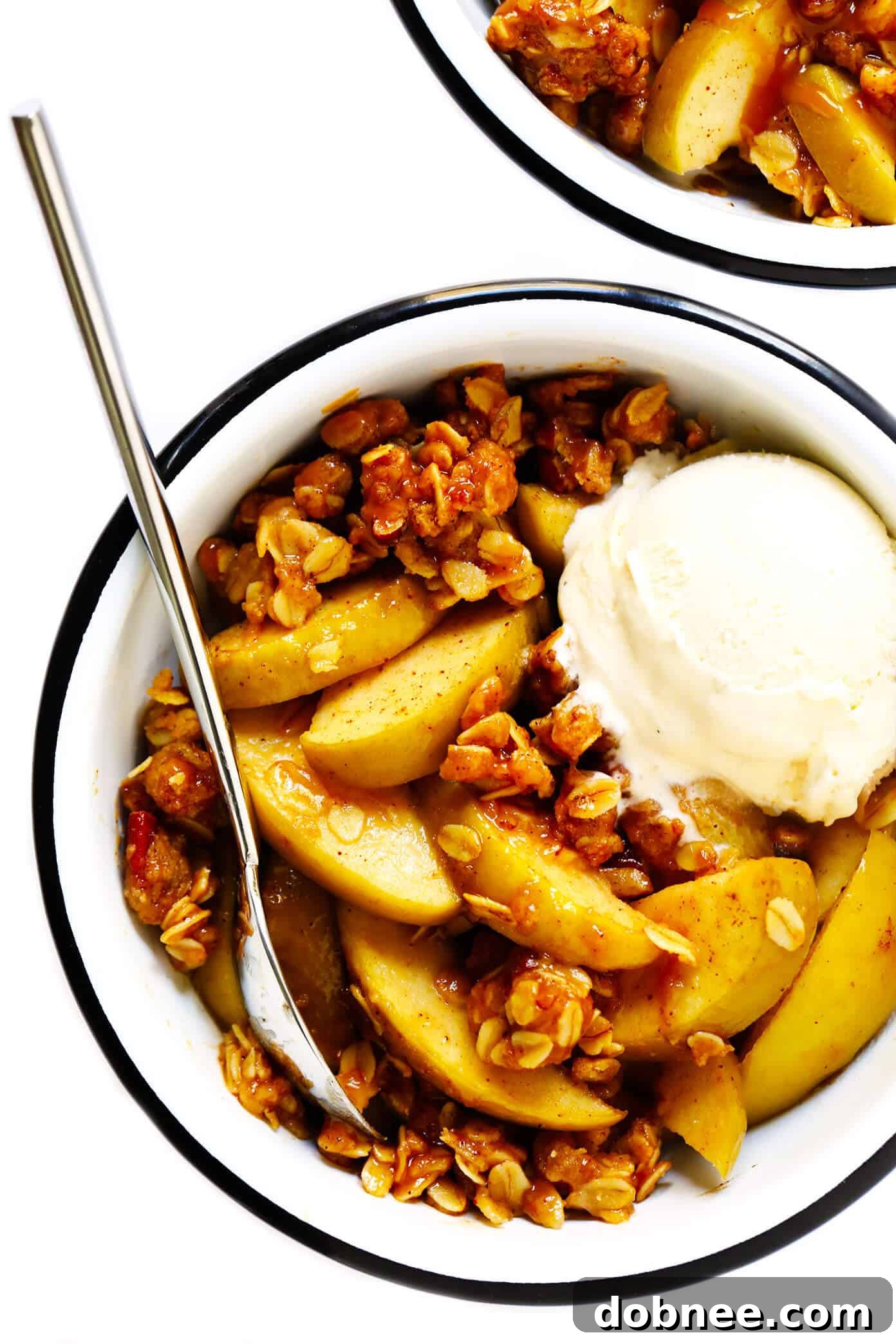Delicious Apple Crisp Recipe with a golden, crunchy topping served in a white bowl.