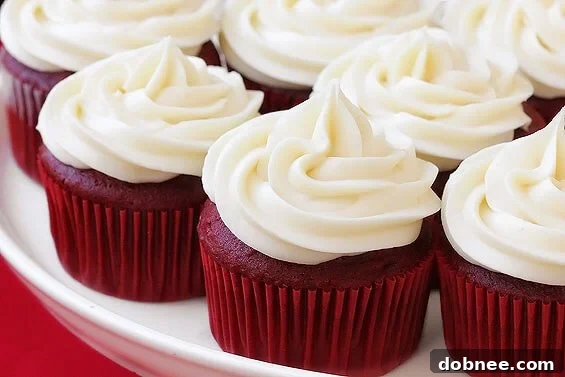 Moist and delicious Red Velvet Cupcakes generously topped with luscious Cream Cheese Frosting, perfect for any celebration.