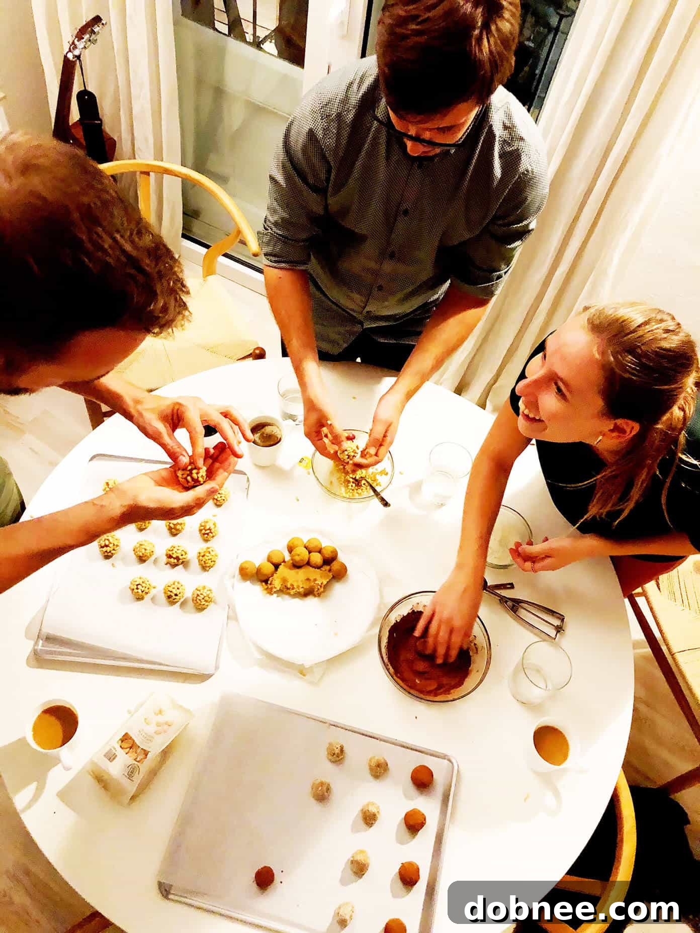 Friends making panellets together in a kitchen