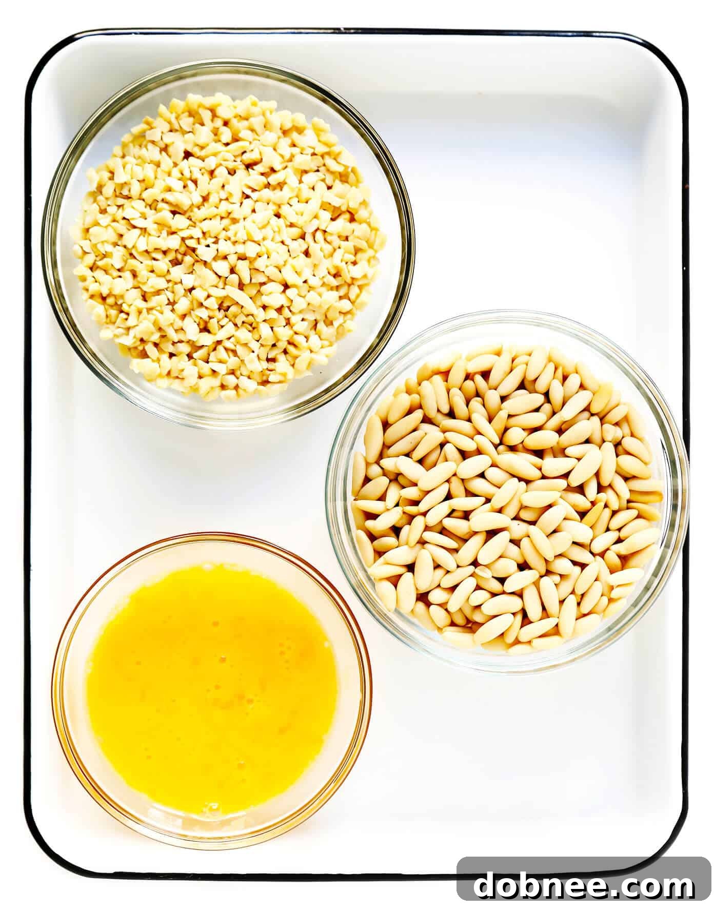 Ingredients for making Panellets: almond flour, potato, sugar, eggs, lemon zest, and pine nuts/almonds