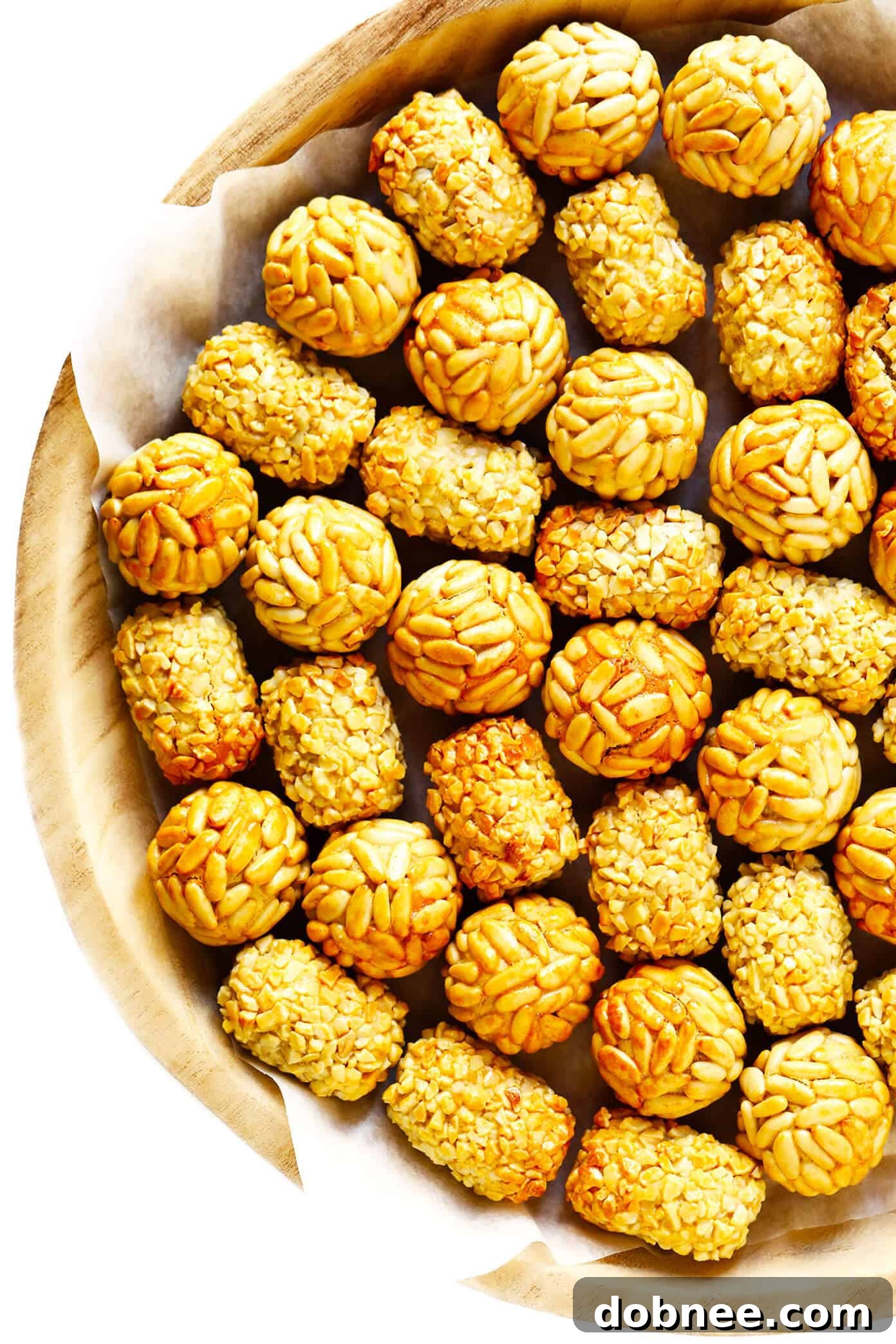 Assortment of Panellets with various toppings on a rustic tray