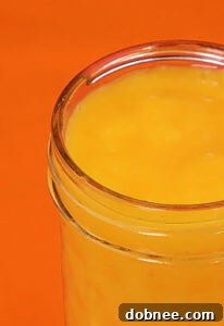 Close-up of a refreshing orange smoothie in a glass jar