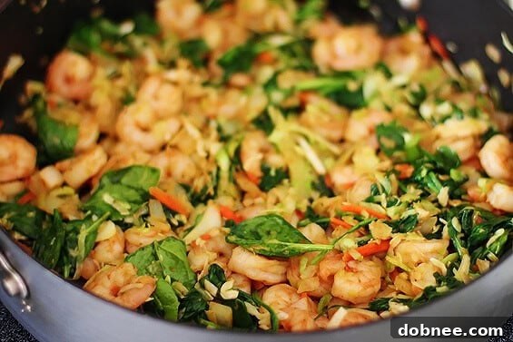 Verde Shrimp Enchiladas With Jalapeno Cream Sauce | The best homemade recipe Close-up of baked Verde Shrimp Enchiladas with a generous drizzle of homemade Jalapeno Cream Sauce, topped with fresh cilantro.