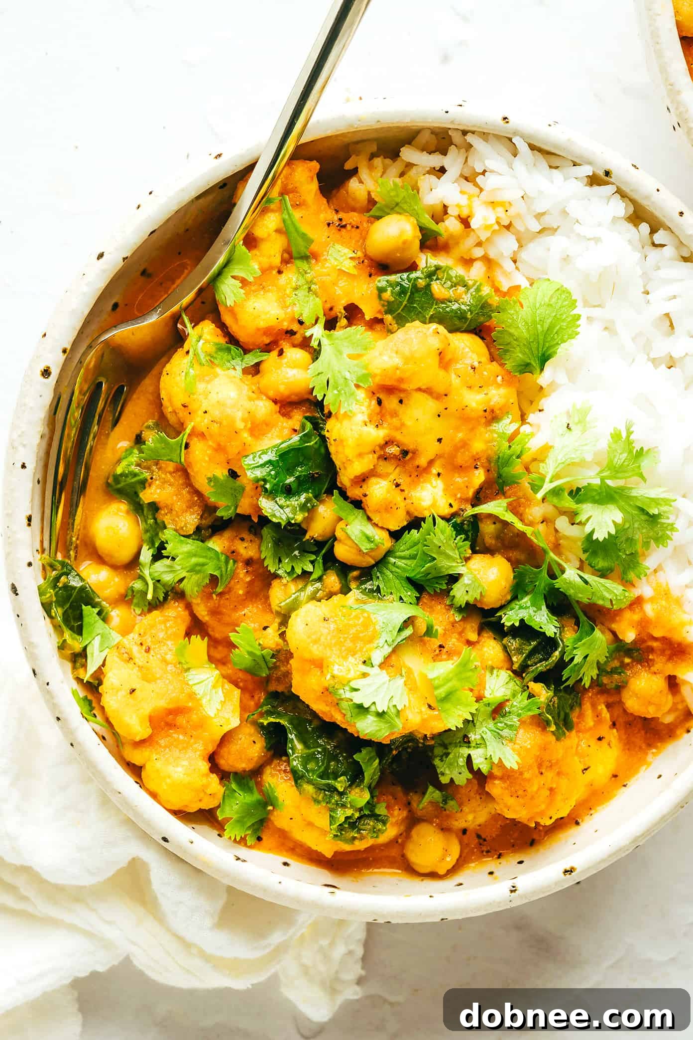 Heartwarming Cauliflower Curry 6 Ingredients for making cauliflower curry, including spices, coconut milk, and tomatoes.