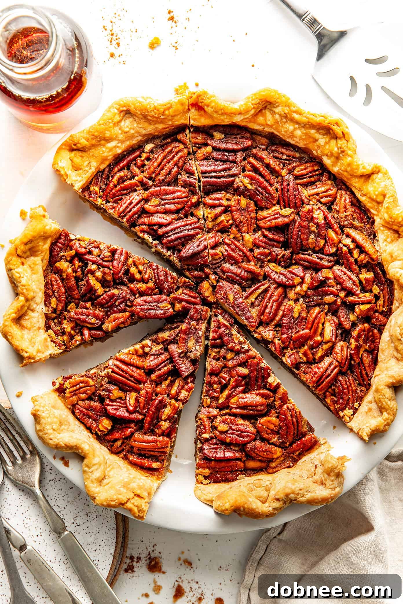 A top-down view of a ready-to-serve pecan pie, showing its golden, glazed surface and perfectly arranged pecans.