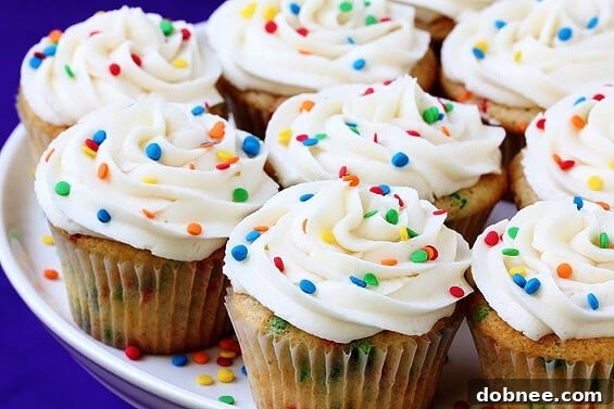 Vibrant homemade Funfetti cupcakes adorned with colorful sprinkles and creamy vanilla buttercream, ready for a celebration.
