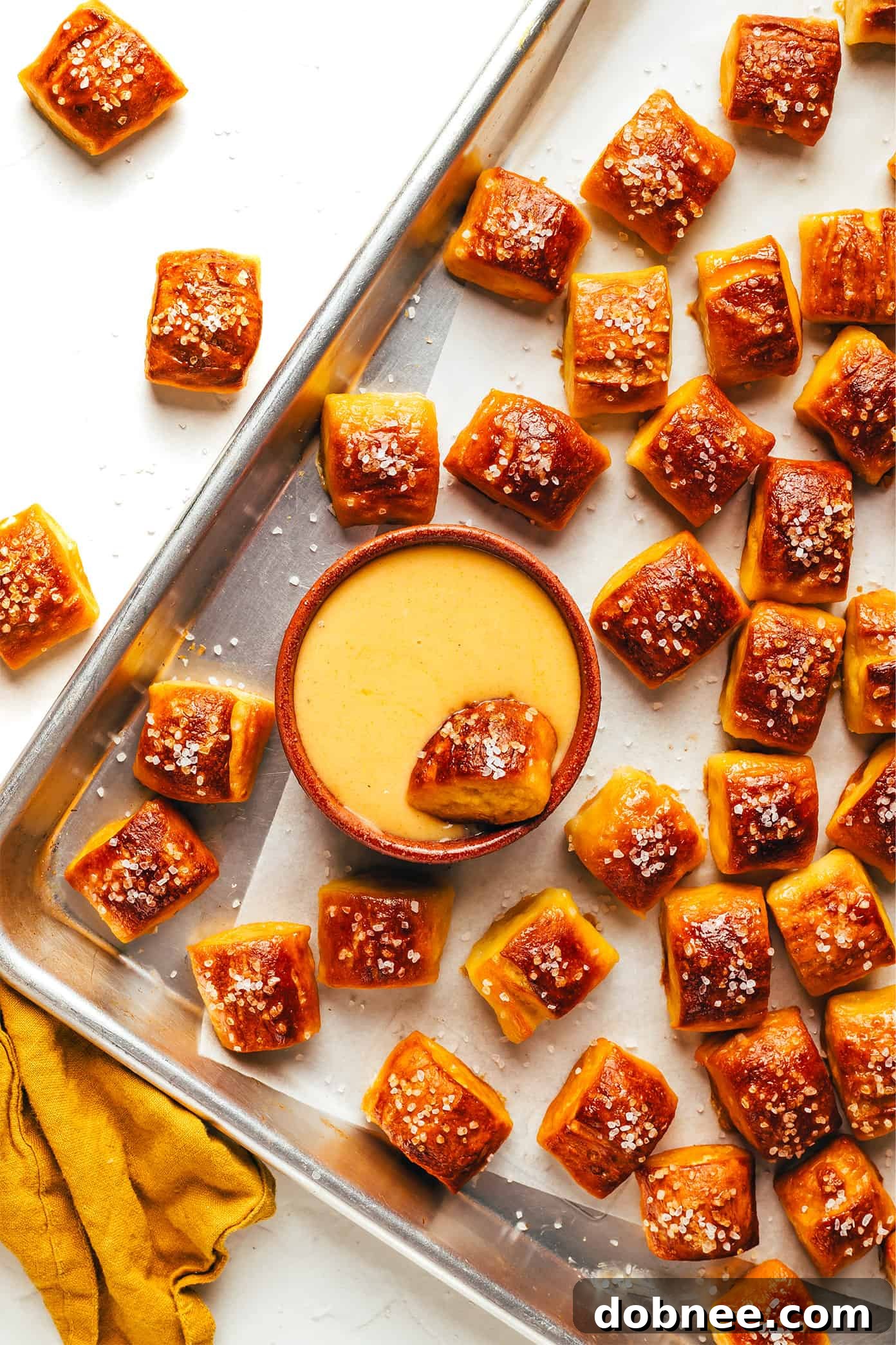 Freshly baked buttery soft pretzel bites on a serving board.