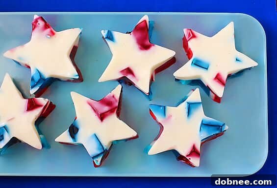 Stained Glass Jello with vibrant red, white, and blue colors, perfect for patriotic holidays, served in a clear dish.