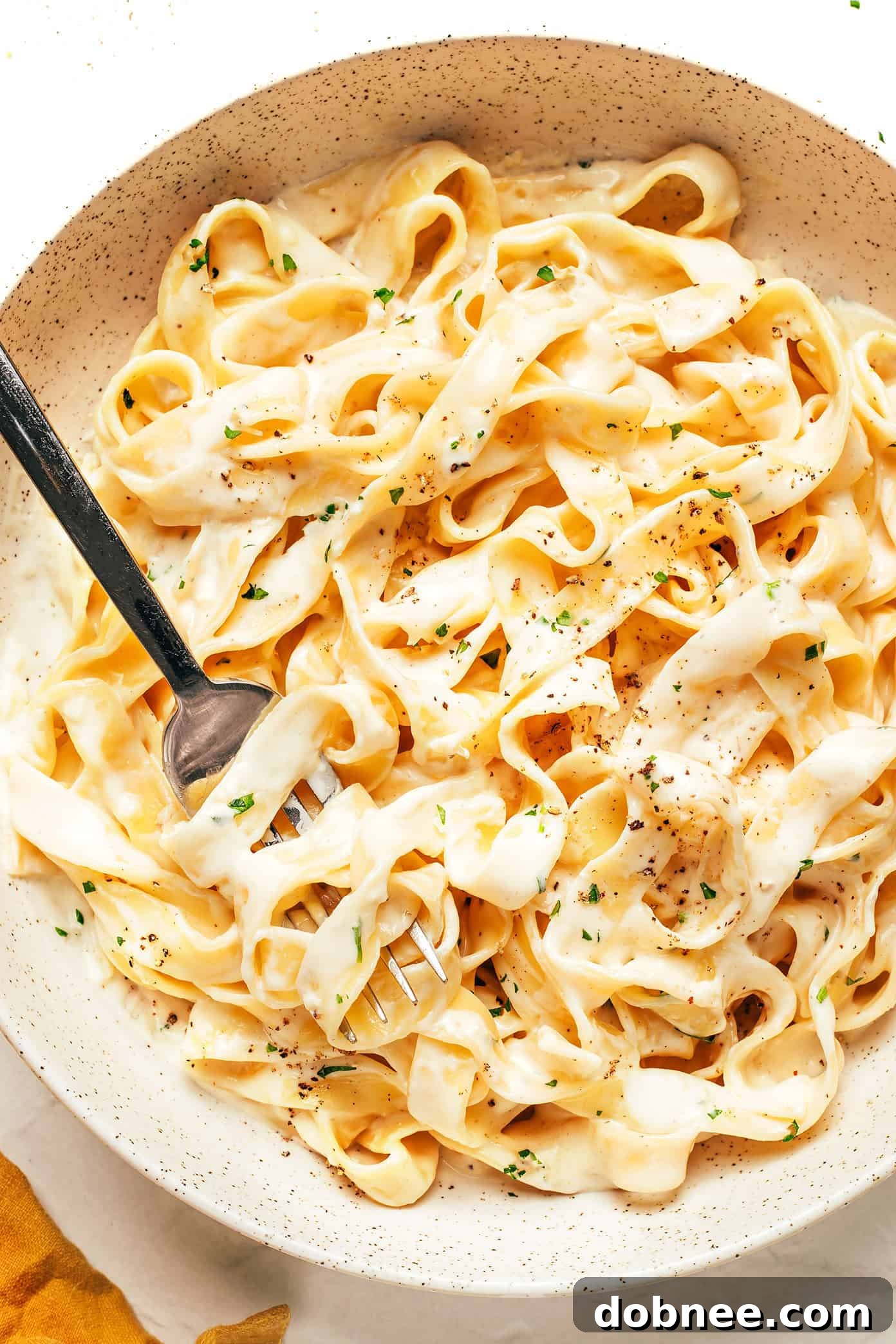 Rich, creamy homemade Alfredo sauce in a skillet, ready to be served over pasta.