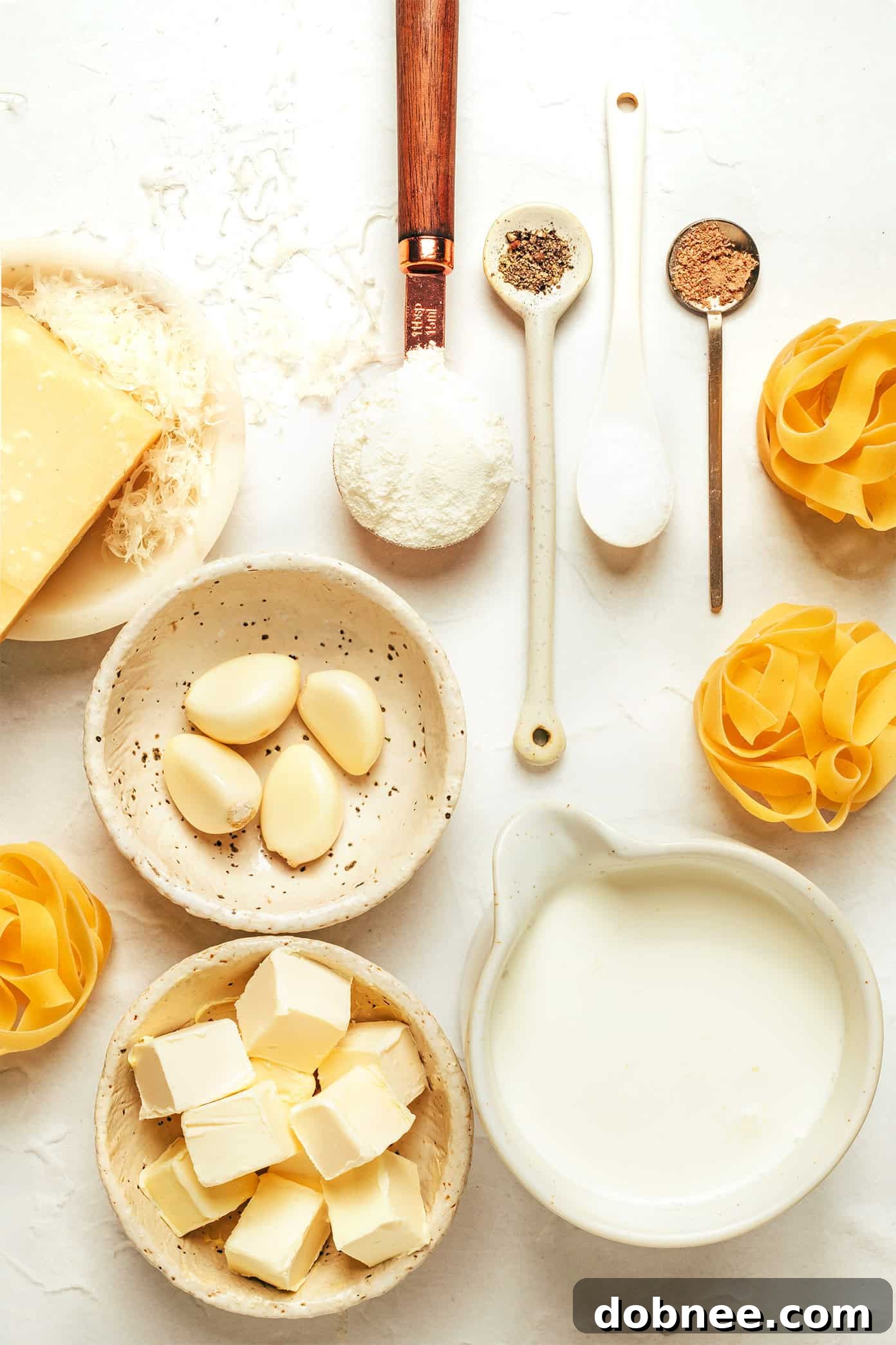 A close-up shot of the creamy Alfredo sauce simmering gently in a saucepan.