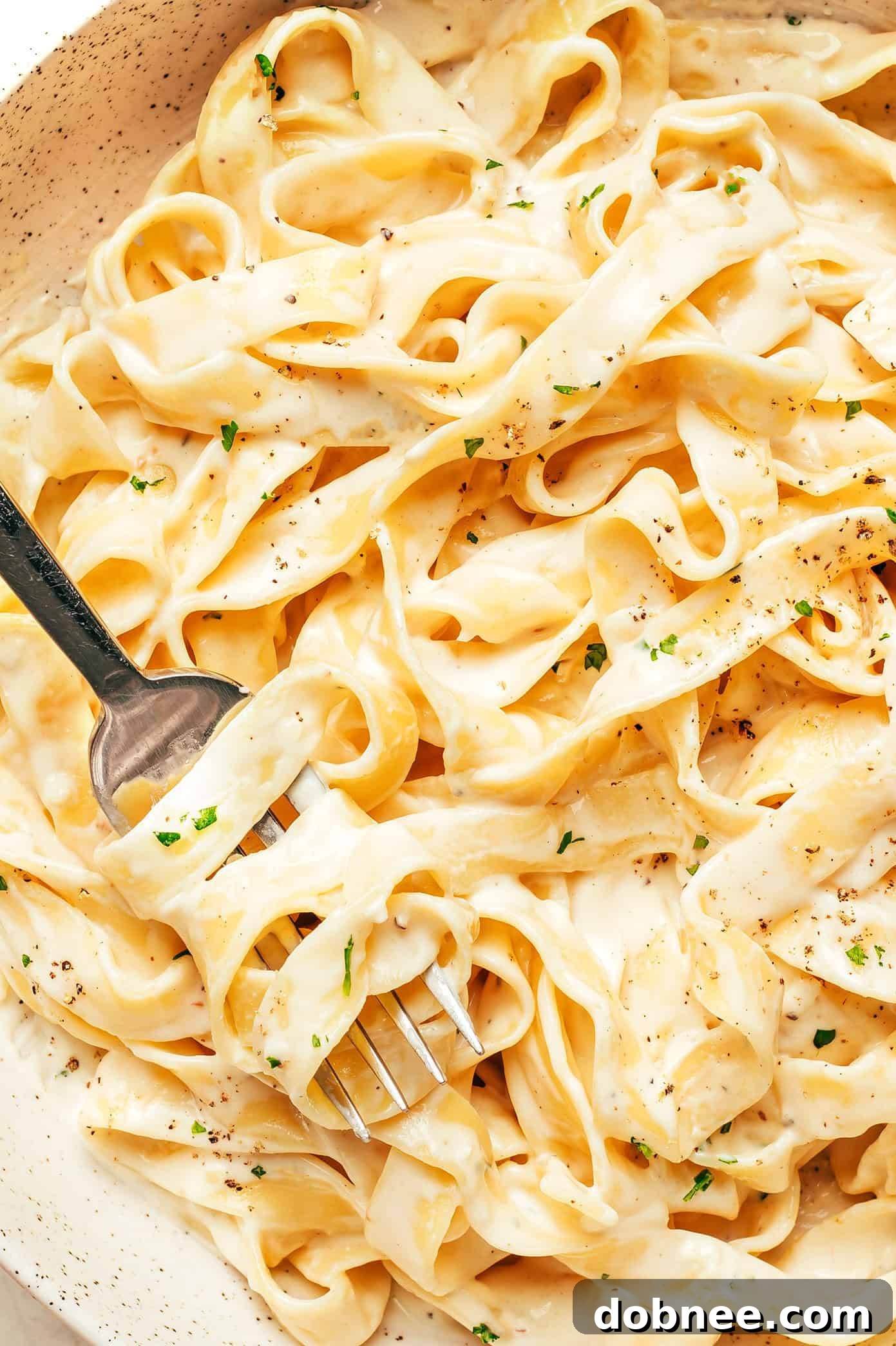 A wooden board showcasing various Italian sauces in small bowls, including a rich Alfredo sauce.