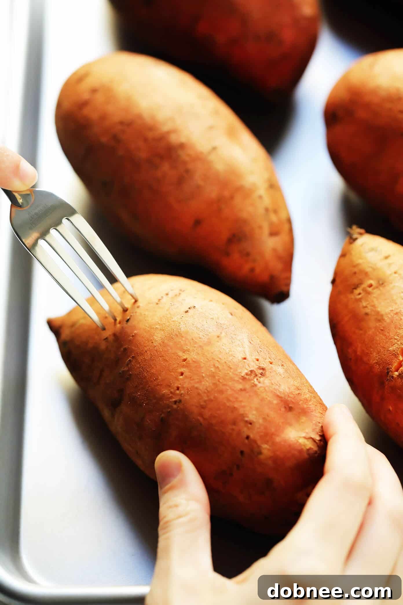 Poking sweet potatoes before baking for perfect results