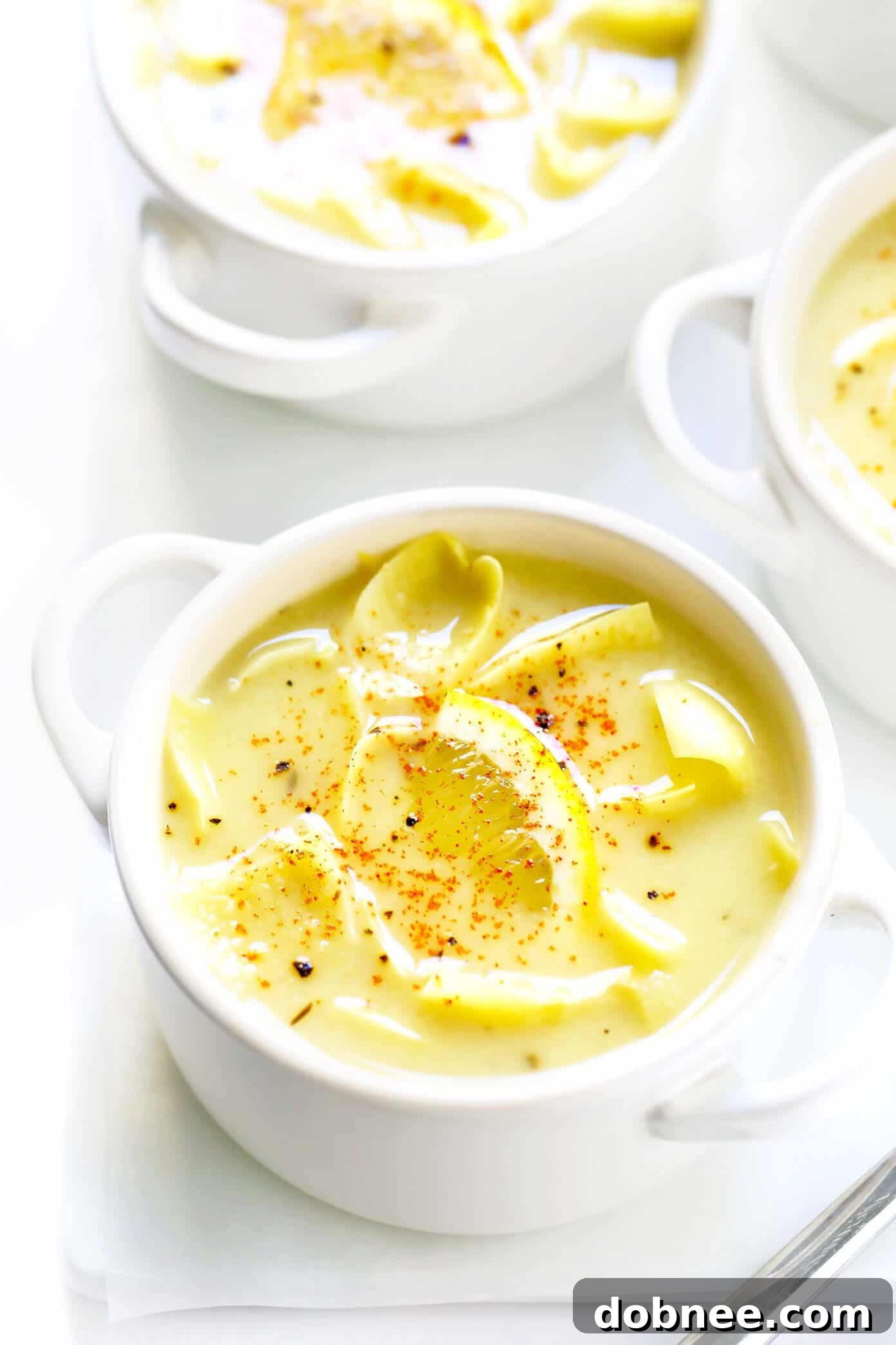Lemony Artichoke Soup with fresh herbs, a healthy and comforting meal option, adaptable for vegan and gluten-free diets.