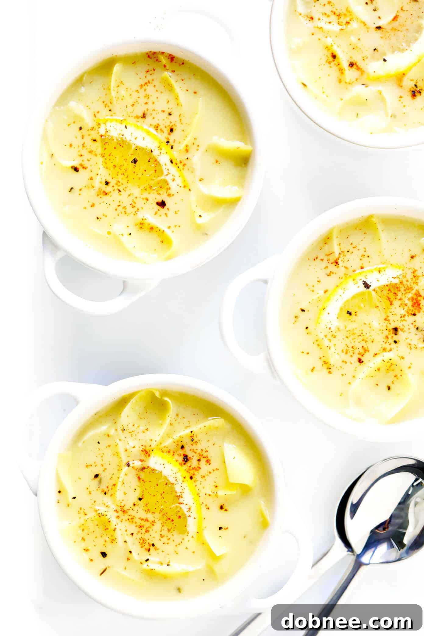 Homemade Lemony Artichoke Soup, served with crusty bread, a perfect dinner idea that is both elegant and easy to prepare.