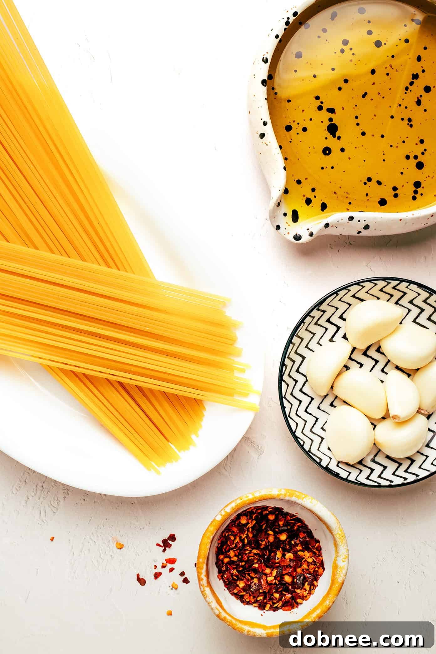 Close-up of freshly cooked Spaghetti Aglio e Olio in a pan, glistening with oil and garlic