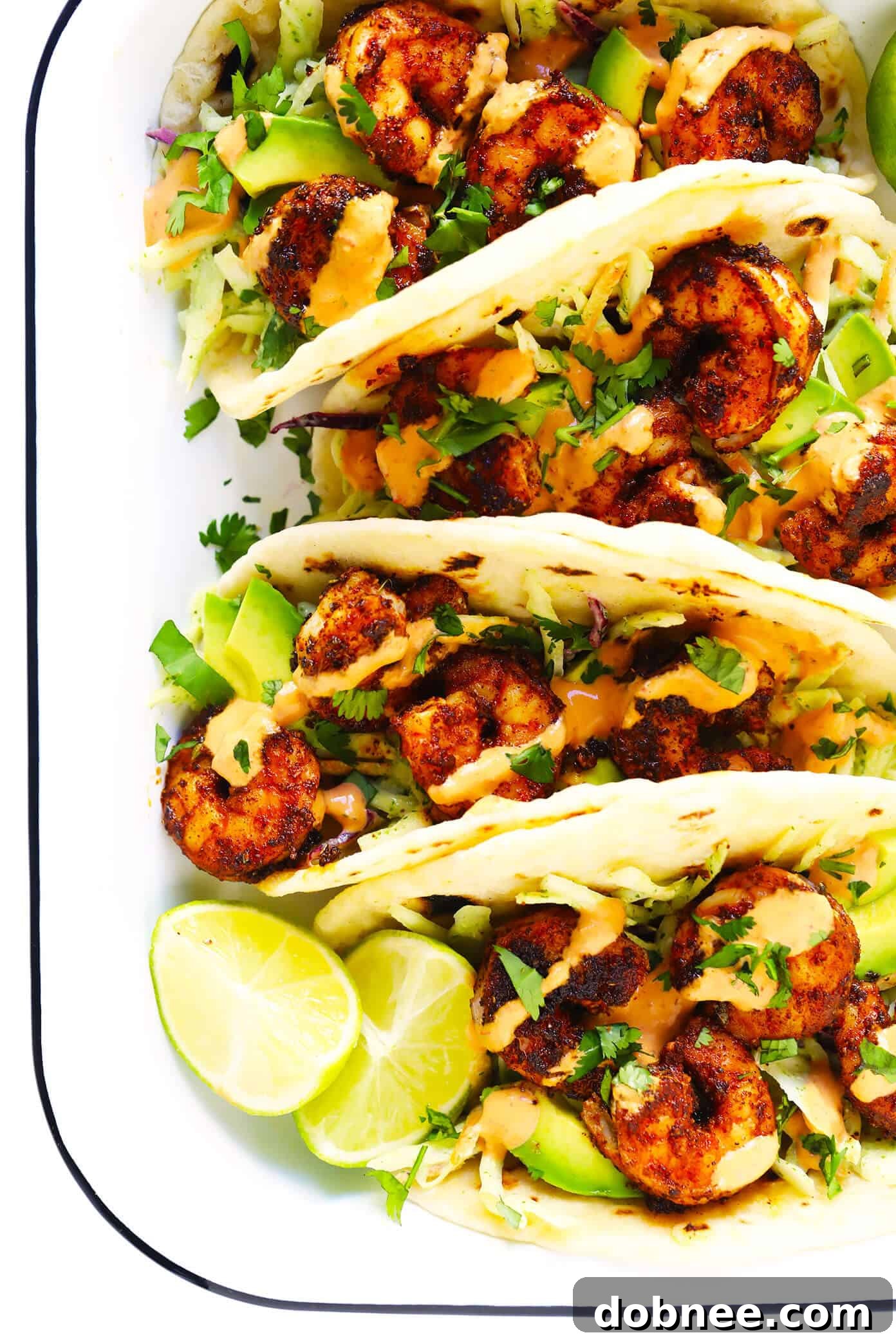 The BEST zesty shrimp tacos recipe! Made with flavorful shrimp, cilantro lime coleslaw, sliced avocado and spicy chipotle crema. Kick them up a notch with homemade flour tortillas too! #shrimp #tacos #dinner #mexican #seafood #avocado #slaw #sauce Zesty Shrimp Tacos with Cilantro Lime Slaw and Chipotle Crema