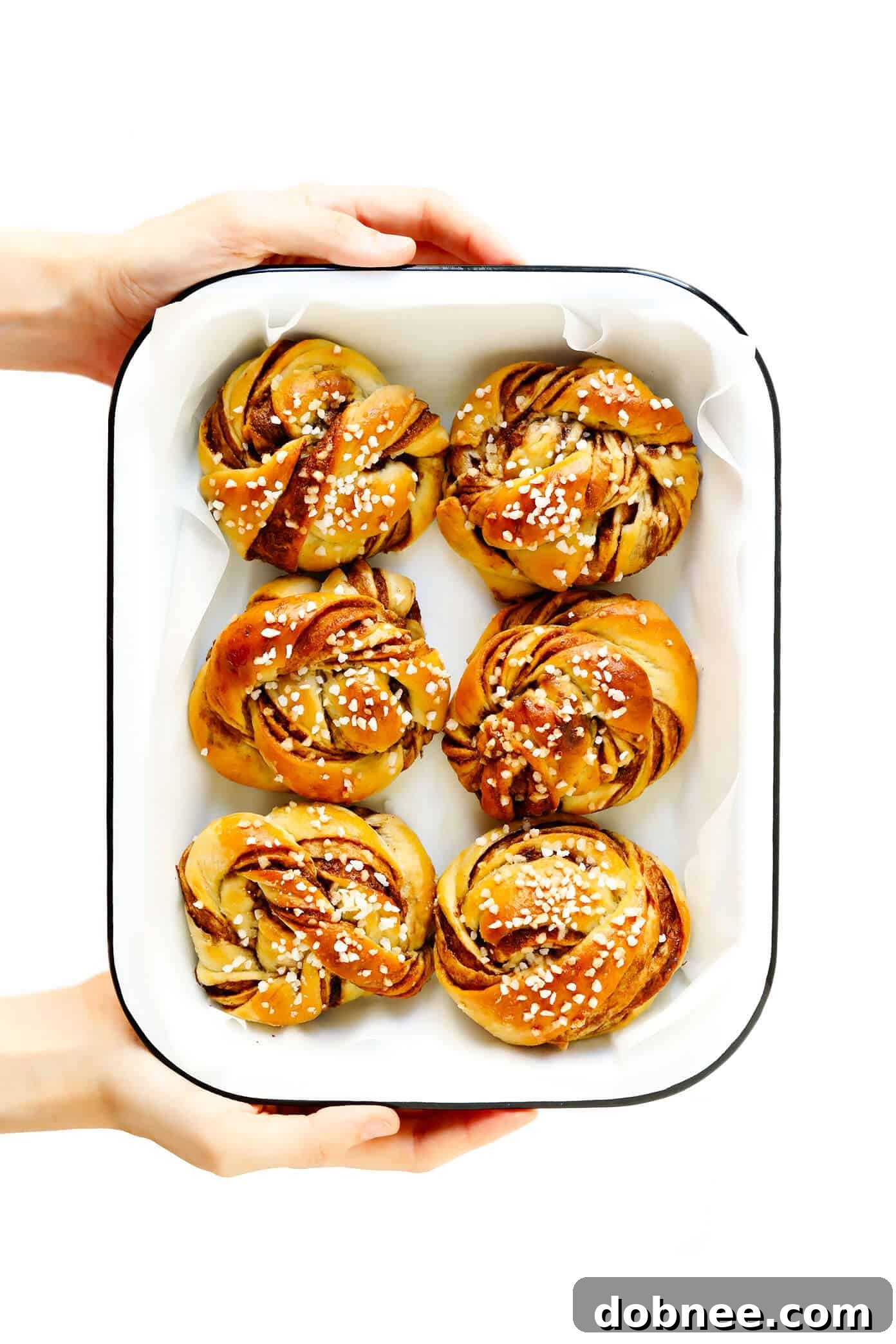 A batch of freshly baked Kanelbullar, perfectly golden, soft, and ready to be enjoyed, showcasing the beauty of this traditional Swedish pastry.