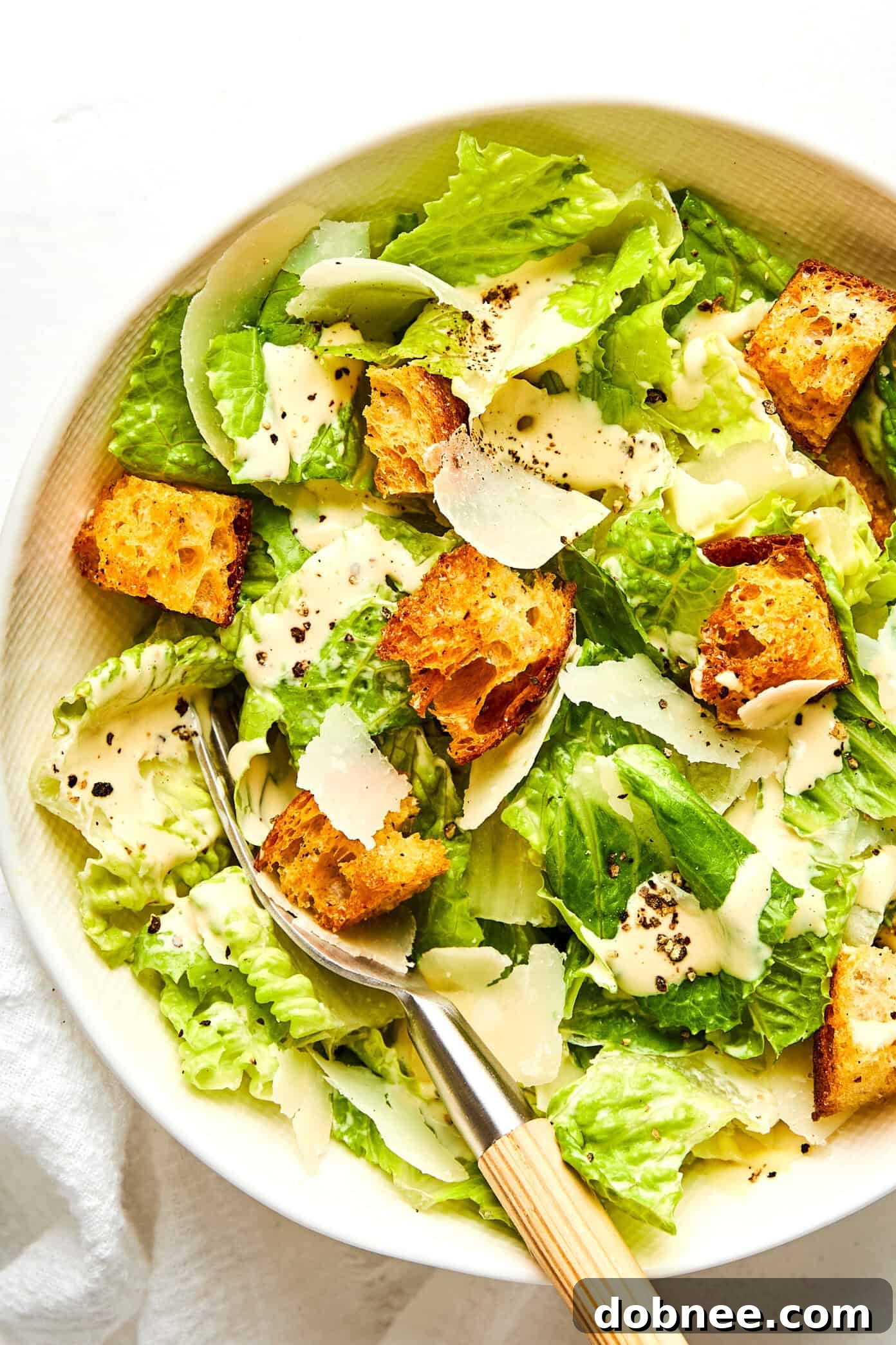 Freshly tossed Caesar salad with homemade croutons and shaved Parmesan.
