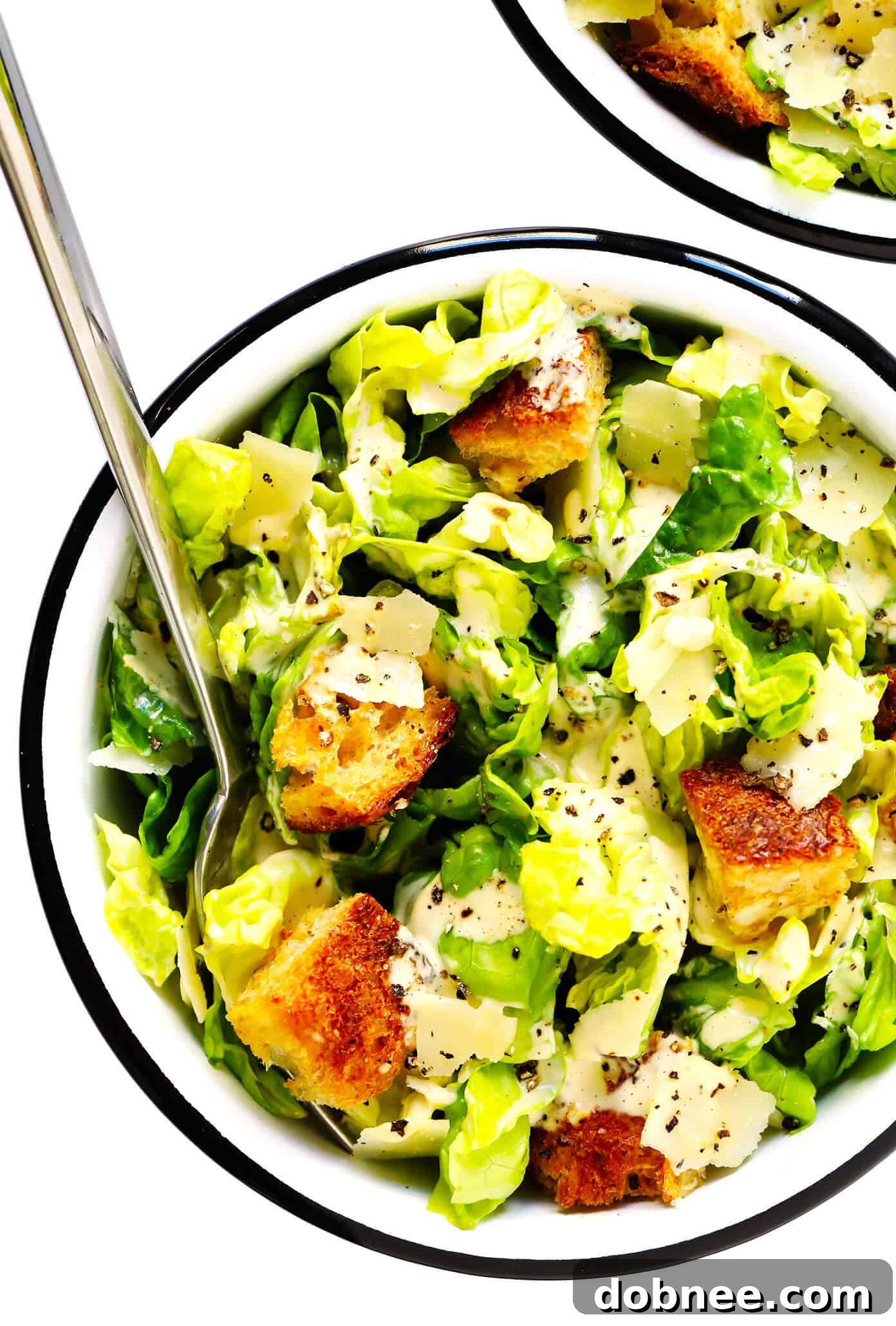 Caesar Salad bowls topped with homemade dressing and croutons