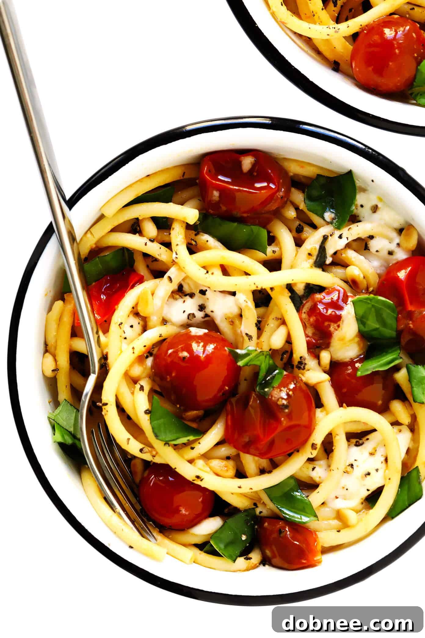Lush garlicky pasta with burst cherry tomatoes, creamy burrata, and fresh basil, perfect for an easy weeknight dinner
